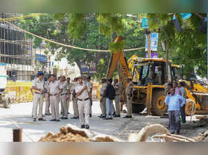 New Delhi: Police personnel stand guard during an anti-encroachment drive by MCD...