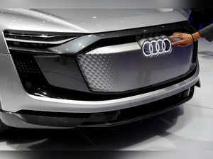 FILE PHOTO: Woman touches logo on Audi e-tron Sportback concept car at the Shanghai Auto Show during its media day, in Shanghai