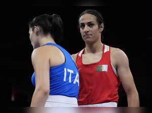 Algeria's Imane Khelif, right, walks beside Italy's Angela Carini after their wo...