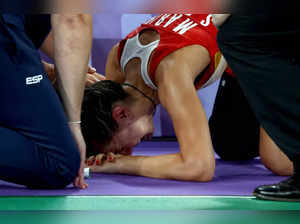 Paris : Carolina Marin of Spain reacts as she is forced to retire with an injury...