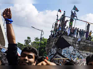 Protesters shout slogans as they celebrate Prime Minister Sheikh Hasina's resign...