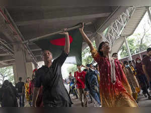 Protesters celebrate after news of Prime Minister Sheikh Hasina's resignation, i...