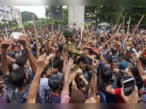 Protesters carry a member of the army on their shoulders as they celebrate Prime...