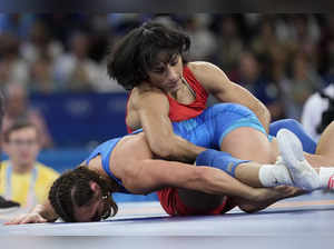 India's Vinesh Phogat and Ukraine's Oksana Livach, left, compete during their wo...