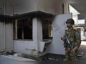 A soldier stands guard at the vandalised museum of Sheikh Mujibur Rahman, father...
