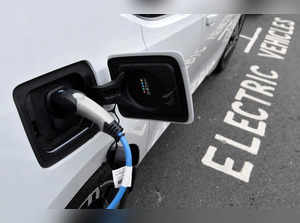 FILE PHOTO: An electric car is charged at a roadside EV charge point, London