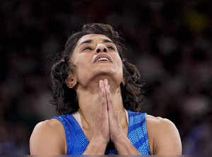 India's Vinesh Phogat reacts after the round of 16 of the women's freestyle 50kg...