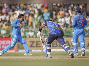 India's Riyan Parag celebrates with teammates after taking the wicket o...