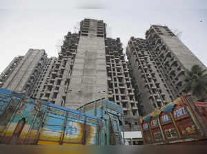 FILE PHOTO: Trucks are parked at the site of an under-construction residential building project, which has been stalled, in Mumbai