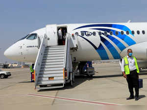 FILE PHOTO: Employee of Luxor's International Airport walks next to an EgyptAir plane, in Luxor