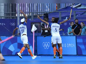 India's Sukhjeet Singh, right, celebrates with teammates after scoring his side'...