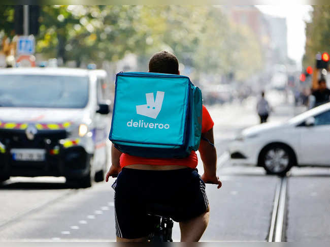 FILE PHOTO: A delivery worker rides a bike in Nice