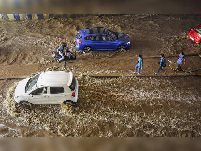 Bengaluru: Vehicles wade through a waterlogged underpass near Jayadeva Hospital,...