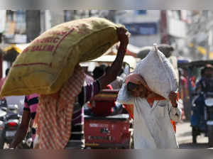 A labourer carries a sack at a wholesale market in the old quarters of Delhi