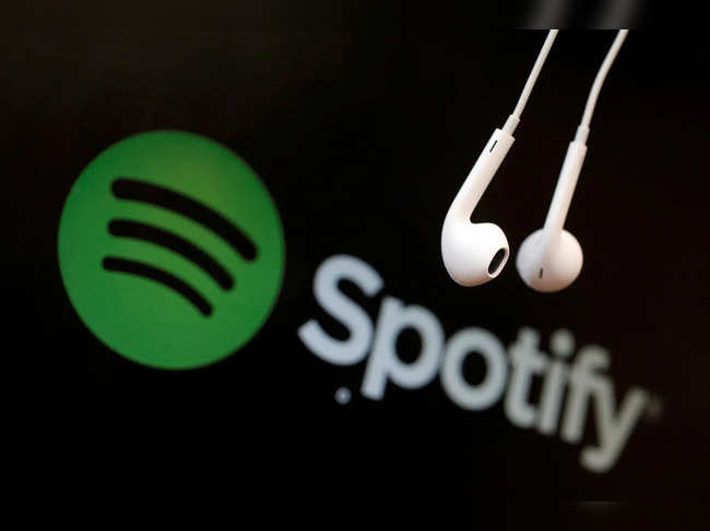 Headphones are seen in front of a logo of online music streaming service Spotify in this illustration picture