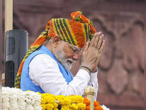 Prime Minister Narendra Modi greets the gathering at the Red Fort