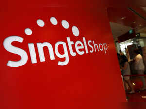 FILE PHOTO: People queue at a Singapore Telecommunication Limited (Singtel) shop in Singapore