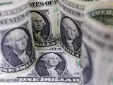 Dollar holds gains on reassuring data, euro slips