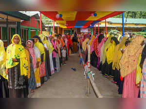 Morigaon: Women stand in queues to cast their votes for the Lok Sabha elections,...