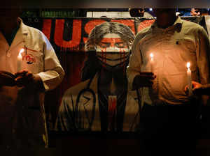 Doctors hold candles during a protest rally in New Delhi