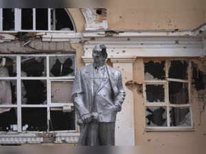 A damaged monument to Soviet founder Vladimir Lenin stands in a central square i...