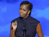 Michelle Obama at DNC says her parents were 'suspicious' of the wealthy but wears dress that costs nearly $3000