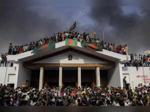 Dhaka : People gather around the residence of Bangladeshi prime minister in Dhak...