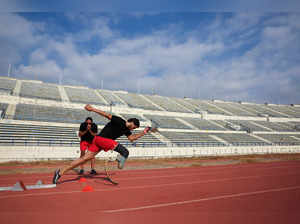 Paralympian Arz Zahreddine, 25, trains with his coach, on a track field in Beirut