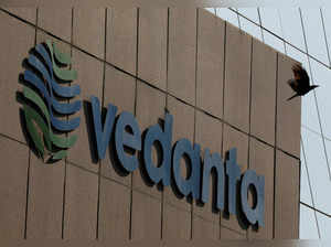 FILE PHOTO: FILE PHOTO: A bird flies past the logo of Vedanta installed on the facade of its headquarters in Mumbai