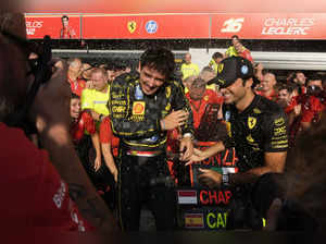 Ferrari driver Charles Leclerc of Monaco celebrates with his teammate Ferrari dr...