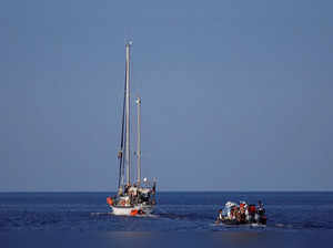 The Nadir sailing boat tows a wooden boat in international waters south of Lampedusa