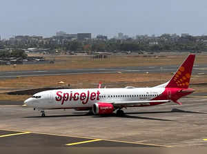 FILE PHOTO: A SpiceJet passenger aircraft taxis on the tarmac at Chhatrapati Shivaji International Airport in Mumbai