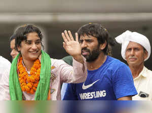 New Delhi: Wrestler Vinesh Phogat with Bajrang Punia being welcomed on her arriv...