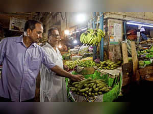 Kolkata: Members of a task force at a vegetable market, in Kolkata. West Bengal ...