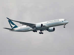 FILE PHOTO: A Cathay Pacific Airways Airbus A350 airplane approaches to land at Changi International Airport in Singapore