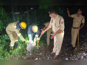 Kanpur: Police and fire services personnel inspect an LPG cyclinder after an att...