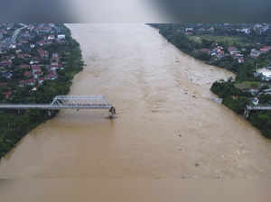 Flooding sweeps away a bus and a bridge collapses in Vietnam as storm deaths rise to 59