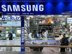 FILE PHOTO: People shop inside a store selling Samsung mobile phones and accessories in Mumbai