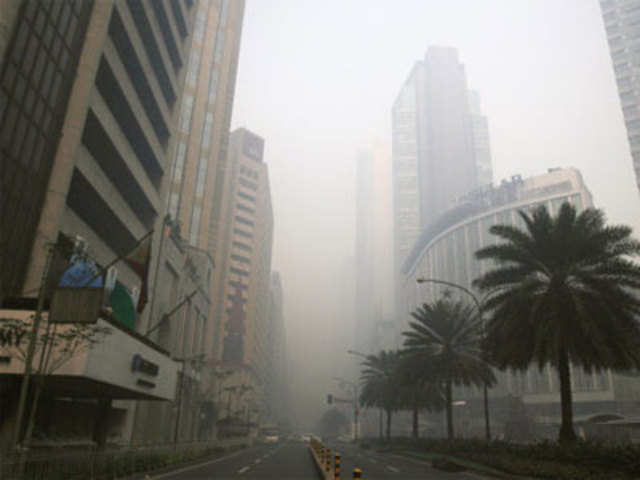 Smog from the New Year revelry covered buildings at the Makati's financial district of Manila