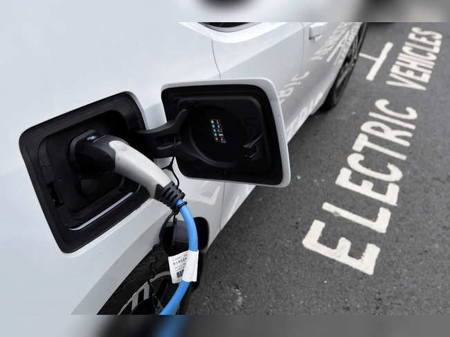 FILE PHOTO: An electric car is charged at a roadside EV charge point, London