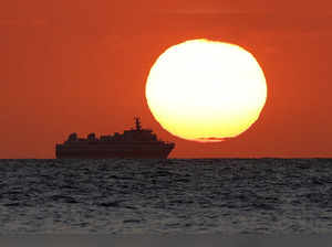 A passenger ship is seen during sunset in Dili