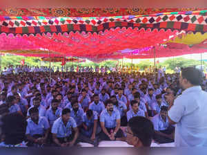 Workers of a Samsung facility listen to a speaker during a strike to demand higher wages at its Sriperumbudur plant