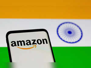 FILE PHOTO: Smartphone with Amazon logo is seen in front of displayed Indian flag in this illustration taken