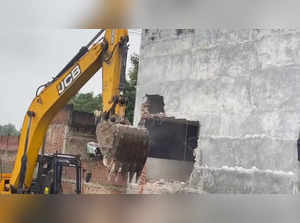 **EDS: SCREENSHOT VIA PTI VIDEO** Ayodhya: A bulldozer being used to demolish il...