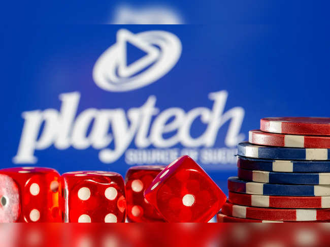 Gambling cubes and chips are seen in front of displayed Playtech logo in this illustration taken