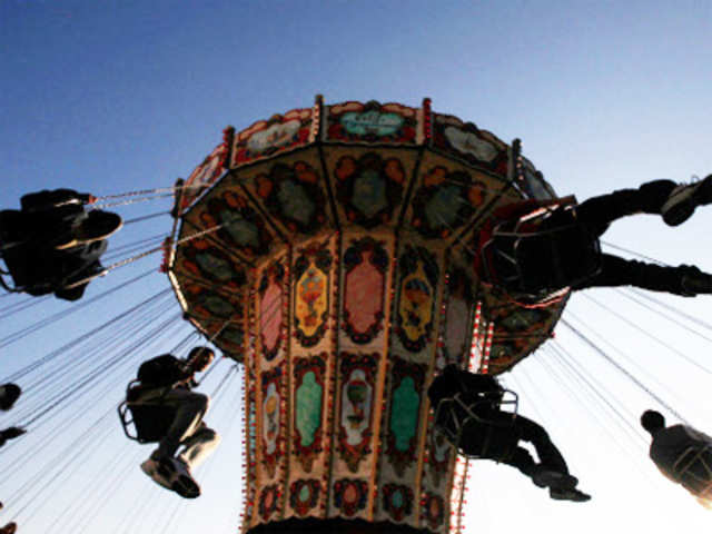 People enjoy ride on swing carousel in Athens