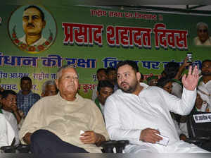 Patna: RJD chief Lalu Prasad Yadav and party leader Tejashwi Yadav during an eve...