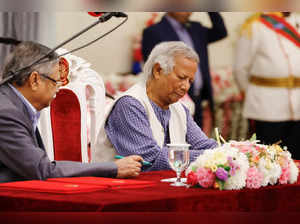 FILE PHOTO: Nobel laureate Muhammad Yunus signs the oath book as the country’s head of the interim government in Bangladesh at the Bangabhaban, in Dhaka