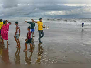 Puri: Beach guards ask tourists to stay away from the rough sea amid the formati...