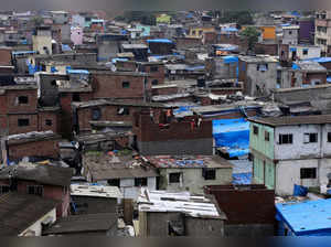 FILE PHOTO: Labourers construct a structure amidst shanties in Dharavi, Mumbai